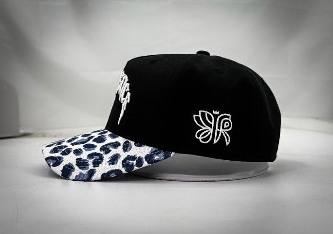 RESILIENCE 5 PANEL HAT IN LEOPARD PRINT & BLACK