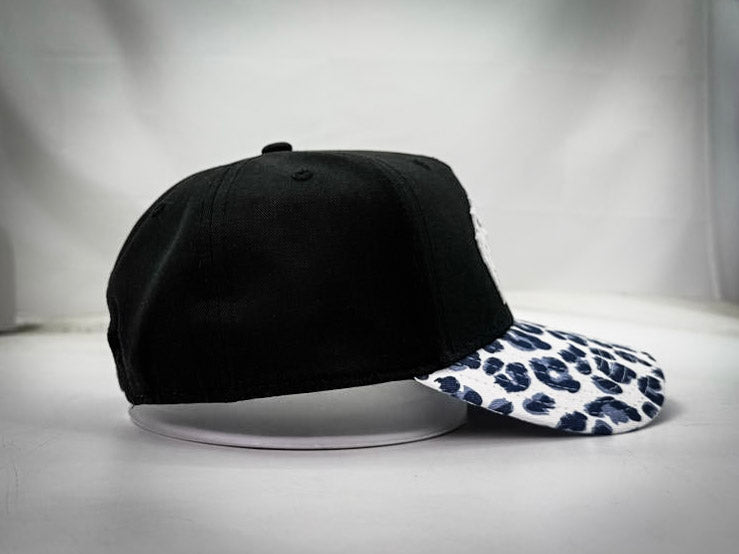 RESILIENCE 5 PANEL HAT IN LEOPARD PRINT & BLACK