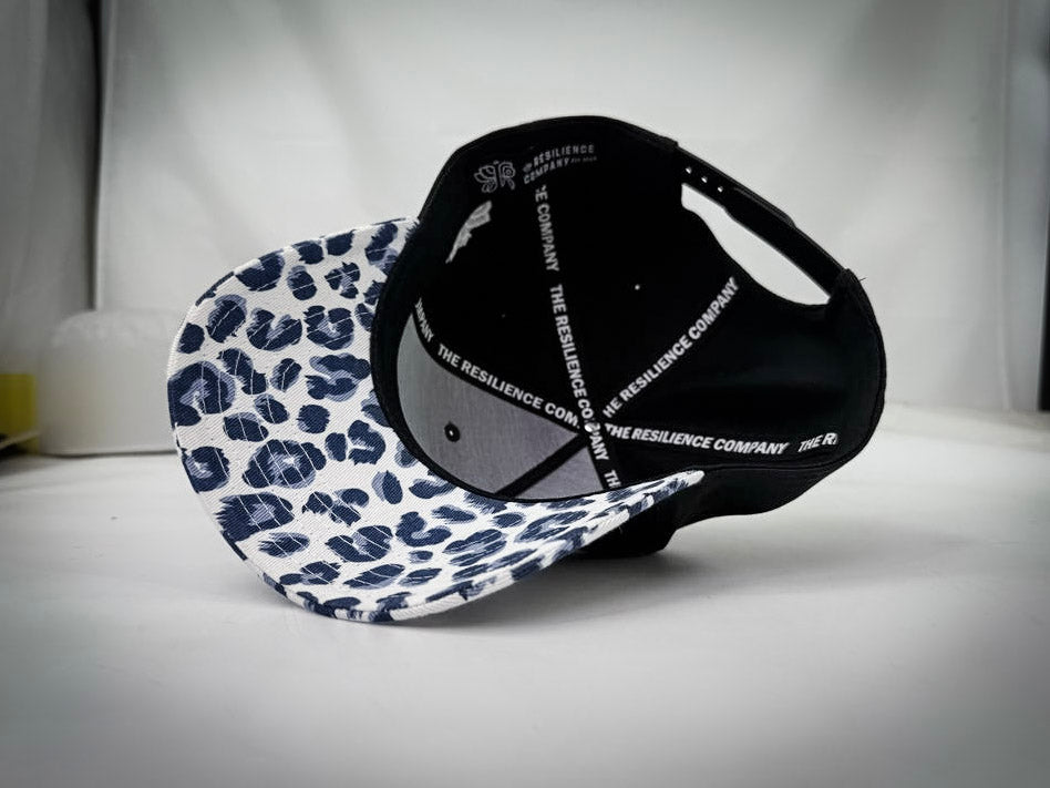 RESILIENCE 5 PANEL HAT IN LEOPARD PRINT & BLACK